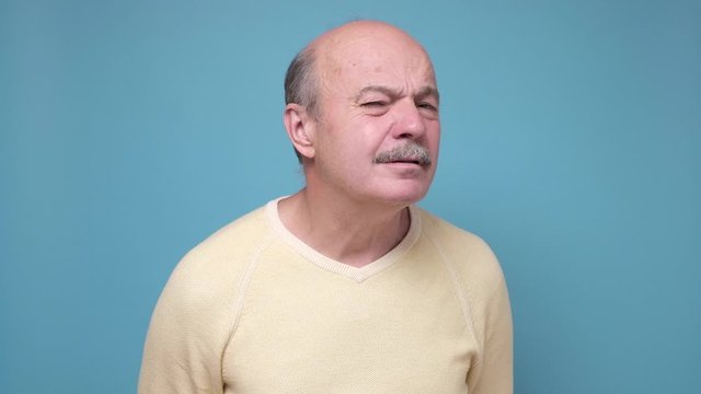 Stunned senior man being troubled to listen advices of wife