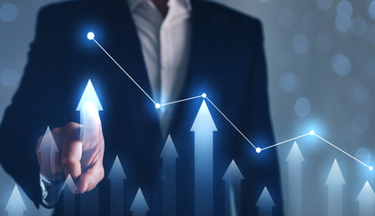 Businessman drawing on screen growing graph. Business development concept. 