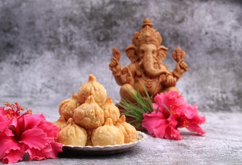 Ganesh Puja - Sweet Modak food offered on Ganpati festival or Chaturthi in India. in silver plate