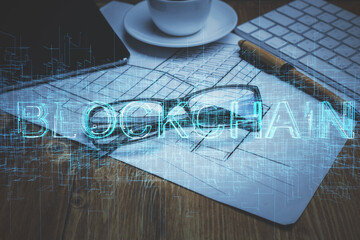 Crypto theme hologram with glasses on the table background. Concept of blockchain. Double exposure.