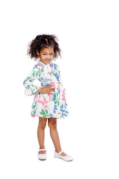 Portrait of pretty little african american girl in white floral dress on white background