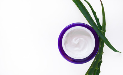 Background with natural cosmetics made from aloe vera juice on white, jars of face cream copy space