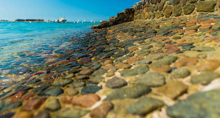 beautiful stone beach coasline background under hot summer sun