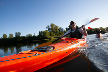 Kayaking. People paddling a kayak. Canoeing. Paddling.