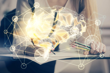 Multi exposure of woman's writing hand on background with brain hud. Concept of learning.