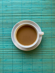 white coffee cup on turquoise