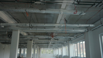 The office is in repair white walls light burning building materials builder building construction contractor engineer industrial male renovation technician development design project slow motion