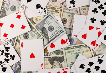 American dollars, banknotes, cash money with playing, gambling poker cards background and texture