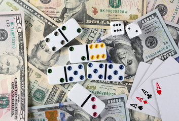 American dollars, banknotes, cash money with playing cards, dominoes and gambling dice, background and texture