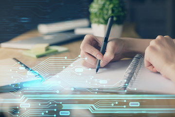 Double exposure of hands making notes with digital coding icons. Computer learning concept.