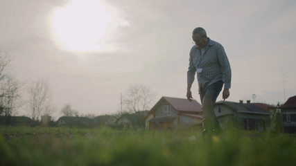 Portrait man farmer in nature checks the ground on field green meadow park adult agriculture garden male worker casual one person close up