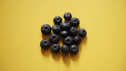 Delicious fresh blueberry on yellow background, space for text