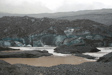 View of the bottom of the Glacier, the hash of the volcano and the rock during summer time in Iceland