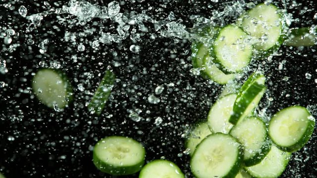 Super slow motion of cucumber pieces flying up in the air with water splashes. Filmed on high speed cinema camera, 1000 fps.