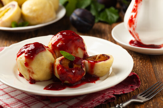 Dumplings with plums, topped with plum sauce or served with cream and sugar.