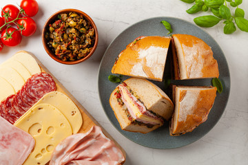 Muffuletta. Sandwich with cheese, ham and olive paste. A traditional recipe in New Orleans.