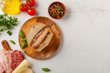 Muffuletta. Sandwich with cheese, ham and olive paste. A traditional recipe in New Orleans.