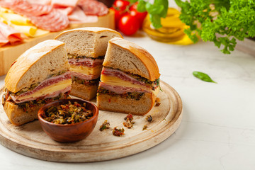 Muffuletta. Sandwich with cheese, ham and olive paste. A traditional recipe in New Orleans.