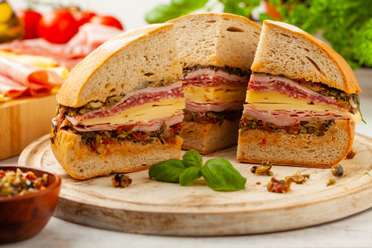 Muffuletta. Sandwich with cheese, ham and olive paste. A traditional recipe in New Orleans.