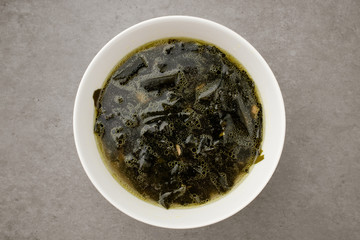 Seaweed soup in a bowl on a white background