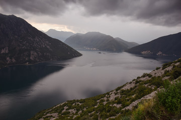 Naklejka na ściany i meble beautiful Bay of Kotor landscape with rain clouds and mountains seen from above