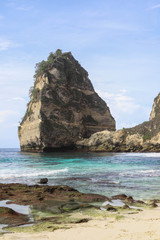 The beautiful Diamond Beach on Nusa Penida Island, Bali, Indonesia. Amazing  view, white sand beach with rocky mountains and azure lagoon with clear water of Indian Ocean 