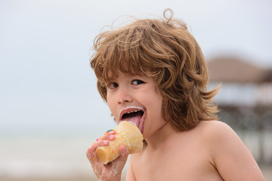 Little kid eating ice cream. Cute boy child eating an ice cream outdoors.