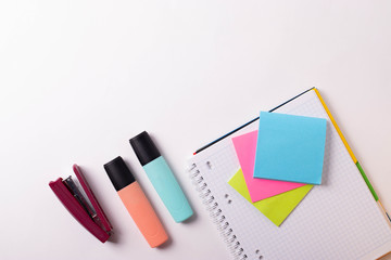 different stationary supplies items on white office or studying desk