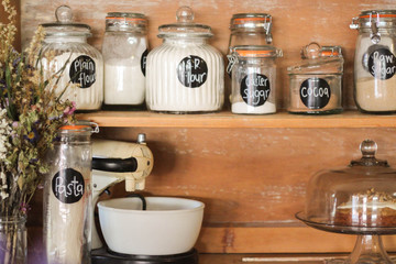 Baking Ingredients displayed on an antique kitchen hutch. A stylish way to store your staples like flour, sugar etc.