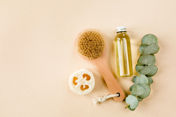 Fototapeta na wymiar Spa treatment concept. Natural/Organic spa cosmetics products with eucalyptus oil, sea salt, massage brush, eucalyptus leaf extract. Spa background