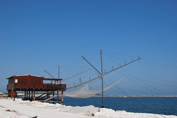 
wooden construction for fishing called trabucco with fixed fishing net