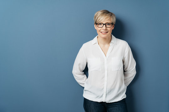 Attractive blond woman wearing glasses on blue