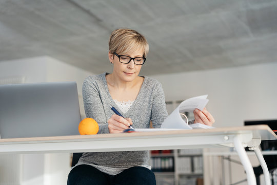 Businesswoman Working On Paperwork In A Binder