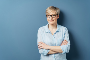 Middle-aged woman in glasses with crossed arms