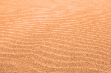 colored sand background marked by the wind