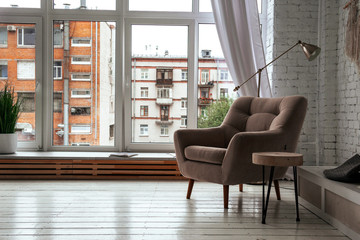  armchair in a bright room with a window background
