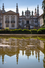Fototapeta na wymiar View of the Solar de Mateus exterior building, iconic of the 18th century Portuguese baroque, lake with building reflection