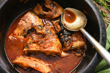 Kerala fish curry with Pearl spot, Karimeen in Alappuzha India. Fresh seafood ingredients of very...