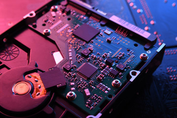 Computer Hard disk drives HDD , SSD on circuit board ,motherboard background. Close-up. With...