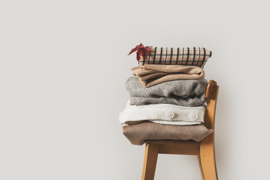 Autumn Cozy And Casual Clothes Stack Close Up On Chair