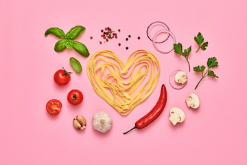 Tomato, basil, spices, champignons, garlic, pasta. Vegan food, creative composition on pink. Fresh basil, tomatoes layout, macaroni heart. Cooking. Italian pasta love concept, top view.