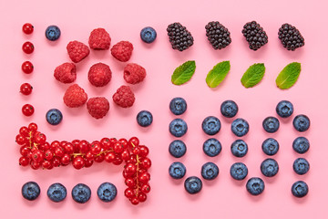Blueberry, blackberry, raspberry, redcurrant layout. Fresh blueberry, berries mix on pink. Red raspberry, mint creative composition. Colorful minimal concept, top view.
