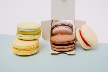Several colorful macaroon cakes on a colored background