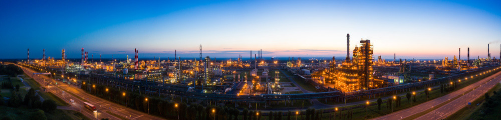 Fototapeta na wymiar Oil refinery plant industry, Refinery factory. oil storage tank, rectification column and pipeline against the backdrop of sunset in summer, Russia.