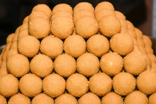 Indian sweet for Diwali , besan laddu or ladoo Indian traditional dessert or mithai arranged as a pyramid in a square dish, Jaipur, Rajasthan, India. 