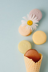 Several colorful macaroon cakes on a colored background