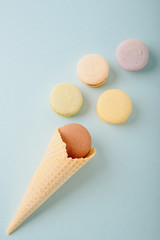 Several colorful macaroon cakes on a colored background