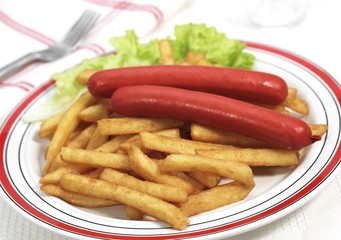 Plate with Sausage and French Fries against White Background
