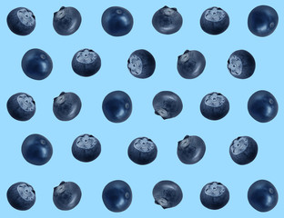 Many fresh blueberries on light blue background. Pattern design