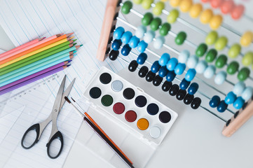 Back to school. Items for the school on a blue wooden table. School supplies on white board background. Back to school concept.